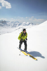 Austria, Kleinwalsertal, Man skiing in Alps - MRF00933