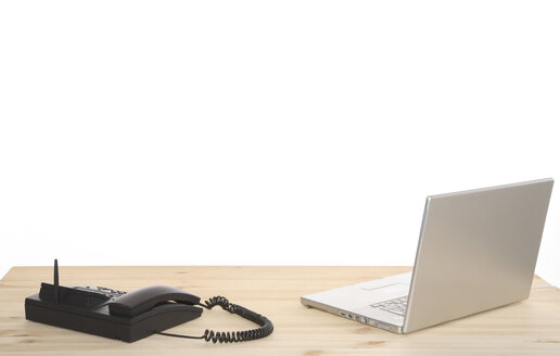 Laptop and telephone on desk, close-up - PKF00185