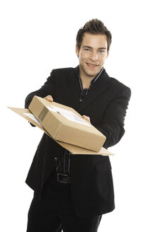 Youndg man holding packages, close-up - PKF00166