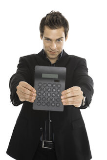 Young man holding calcuator, close-up - PKF00159