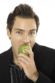 Young man holding green apple, close-up - PKF00152