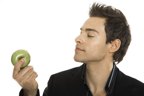 Young man holding green apple, close-up - PKF00151