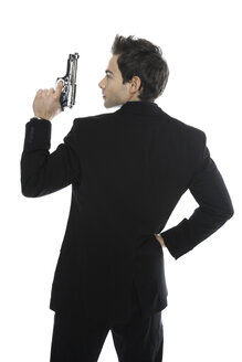 Young man holding hand gun, close-up - PKF00147