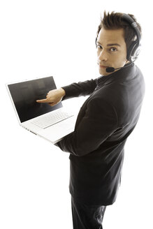 Young man wearing head set, holding laptop, close-up - PKF00139