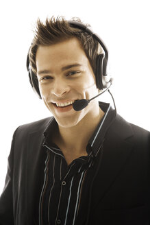 Young man wearing head set, close-up - PKF00137