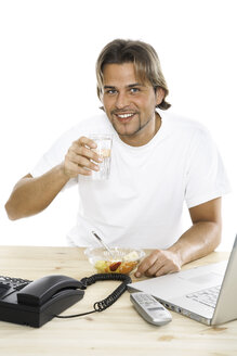Man at desk drinking water, close-up - PKF00120