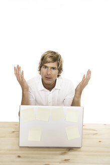 Man sitting at desk with laptop, close-up - PKF00093