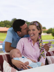 Parents with baby in garden - WESTF06178