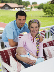 Parents with baby in garden - WESTF06174