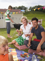 Family in garden, having barbecue - WESTF06081