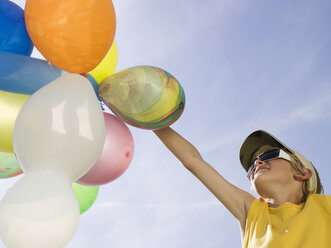 Boy holding balloons, portrait - WESTF06053