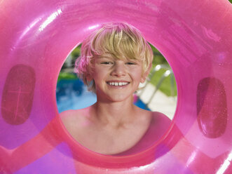 Boy holding pink rubber ring, portrait - WESTF06034