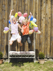 Boy and girl jumping, outdoors - WESTF06030