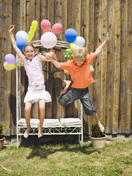 Boy and girl jumping, outdoors - WESTF06029