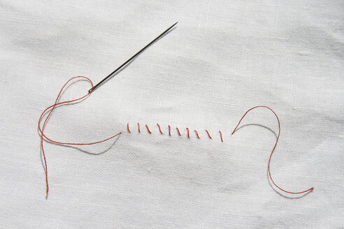 Red seam on white cloth, close-up - TLF00192