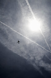 Condensation trails and airplane in sky - TLF00180