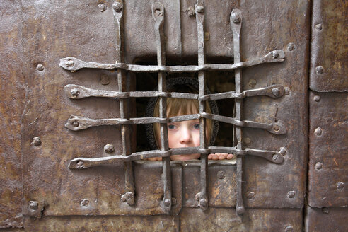 Italy, South Tyrol, Potrait of a girl behind bars - GNF00939