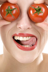 Woman, eyes covered with tomatoes, close-up - MAEF00517