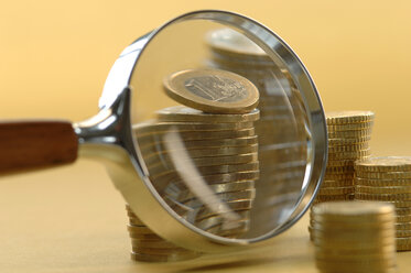 Euro coins under magnifying glass, close-up - ASF03458