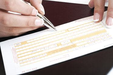 Person filling in a money transfer form - 07569CS-U