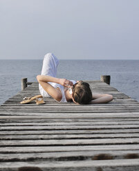 Italy, Lake Garda, Young woman (20-25) using phone - DKF00122