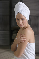 Germany, woman wearing towel turban - BABF00319