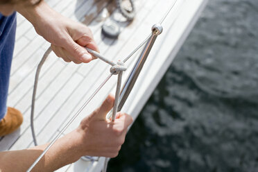 Germany, Baltic Sea, Lübecker Bucht, man tying knot - BAB00457