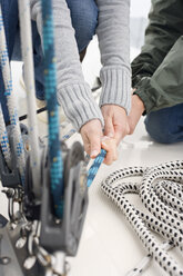 Germany, Baltic Sea, Lübecker Bucht, Hands pulling rope, close-up - BAB00416