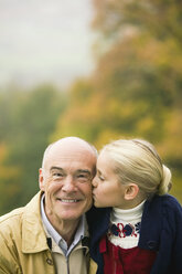 Germany, Baden-Württemberg, SwaGrabian mountains, granddaughter kissing grandfather, portrait - WESTF06292