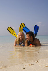 Maldives, Couple wearing snorkeling gear at beach - GNF00960