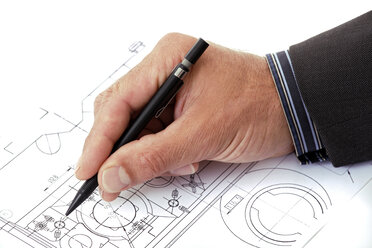 Man's hand pointing at blueprint with pen - TCF00406