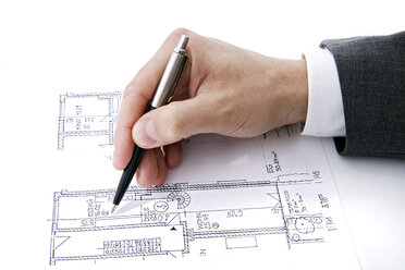 Man's hand pointing at blueprint with pen - TCF00401