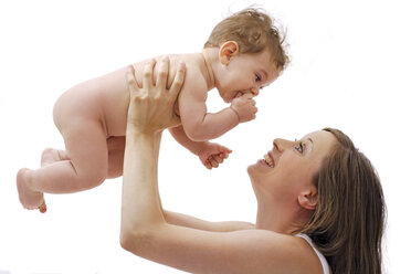 Mother playing with baby boy (6-11 months), studio shot - TCF00362