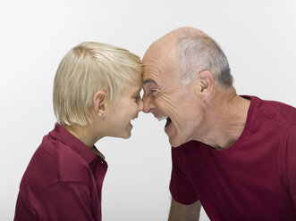 Grandson (8-9) and grandfather, portrait, close-up - WESTF06460