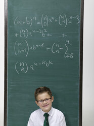 Boy (10-11) in front of a blackboard, portrait - WESTF06392