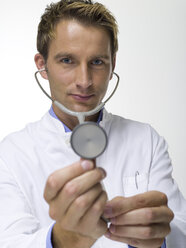 Male doctor holding stethoscope, close-up, portrait - WESTF06378