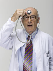 Portrait of a senior male doctor, holding stethoscope - WESTF06371