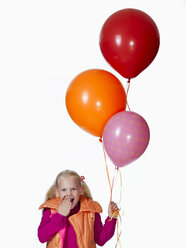 Mädchen (8-9) hält einen Strauß Luftballons, lächelnd, Porträt - KMF01131