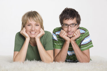 Couple lying on carpet, portrait - WESTF06797