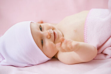 Baby girl (6-9 months) lying on back - SMOF00122