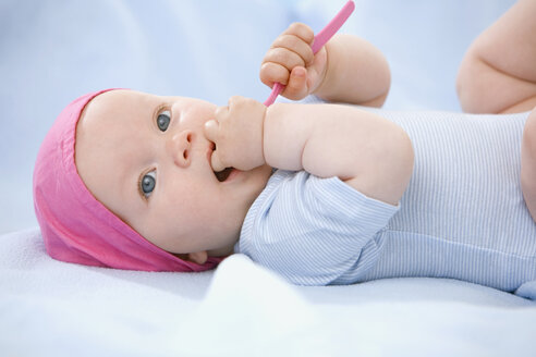 Baby boy (6-9 month) holding tooth-brush - SMOF00110