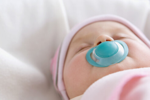 Baby boy (6-9 months) sleeping with pacifer, close-up - SMOF00107