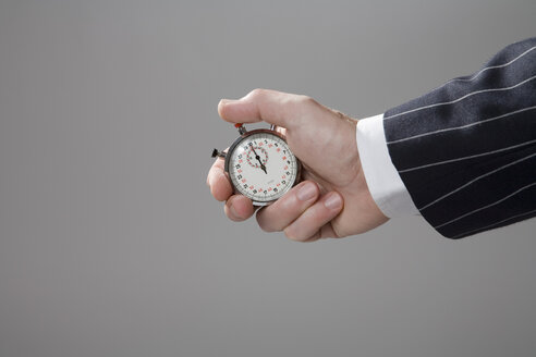 Man holding stop watch, close-up - MAEF00780