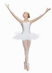 Young ballerina (14-15) standing on pointe in toe shoes,, portrait - KMF01162