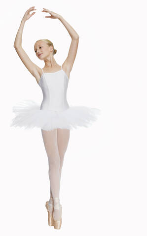 Young ballerina (14-15) standing on pointe in toe shoes,, portrait stock photo