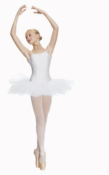 Young ballerina (14-15) standing on pointe in toe shoes,, portrait - KMF01157