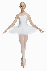 Young ballerina (14-15) standing on pointe in toe shoes,, portrait - KMF01155