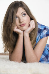 Young on floor, looking up, portrait - CLF00554