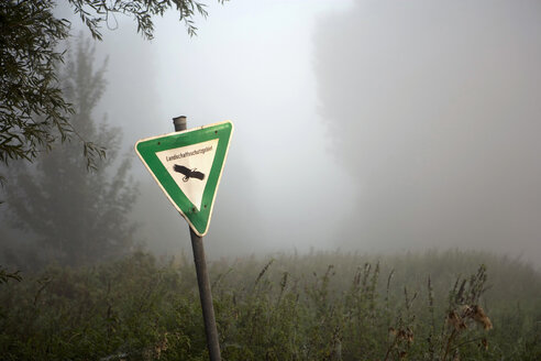 Germany, Nature Reserve Sign, Morning mist in the forest - HKF00062