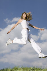 Young woman jumping in mid air - CLF00523